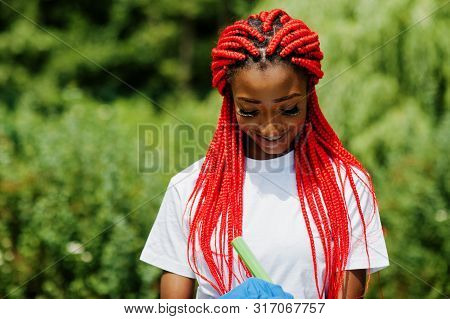 African Red Haired Volunteer Woman With Clipboard In Park. Africa Volunteering, Charity, People And