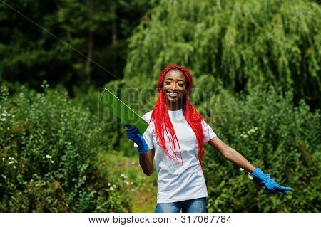African Red Haired Volunteer Woman With Clipboard In Park. Africa Volunteering, Charity, People And
