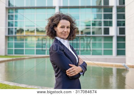 Successful Satisfied Female Executive Posing Near Office Building. Woman Wearing Formal Suit, Standi