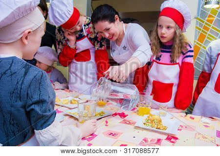 Alchevsk, Ukraine - March 24, 2019: School Cook For Children. Children Stuff Pancakes
