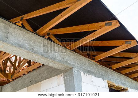 Roof Trusses Covered With A Membrane On A Detached House Under Construction, Visible Roof Elements, 