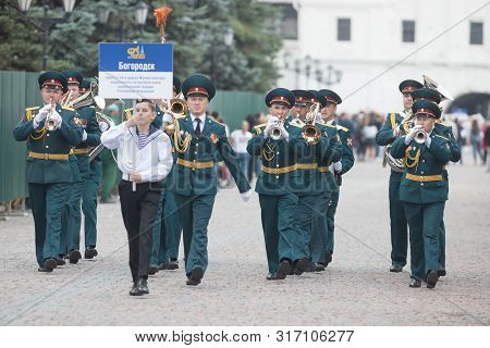 Russia, Kazan 09-08-2019: A Wind Instrument Parade - A Man Holding A Plate That Says Military Orches