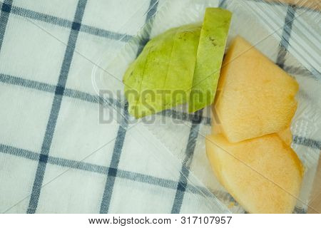 Fresh Of Guava And Cantaloupe In Transparent Plastic Box