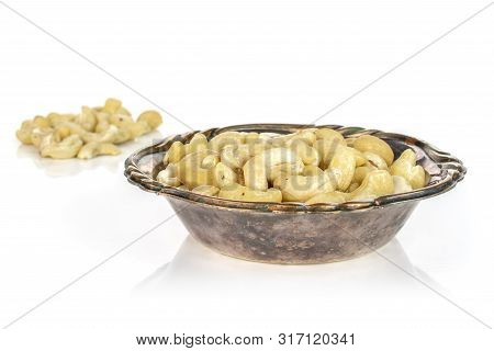 Lot Of Whole Unsalted Beige Cashew In Metal Bowl Isolated On White Background