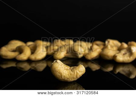 Lot Of Whole Unsalted Beige Cashew Isolated On Black Glass