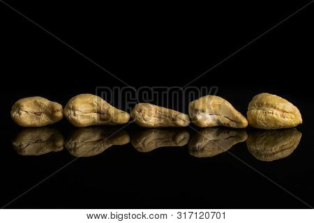 Group Of Five Whole Unsalted Beige Cashew Isolated On Black Glass