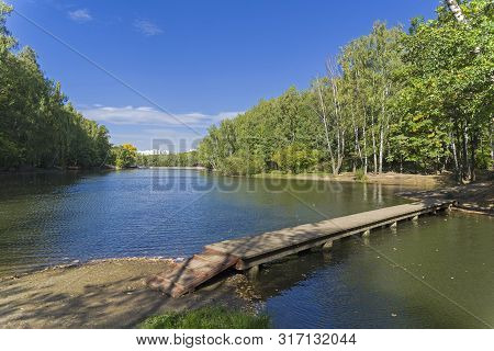 Pond In The Landscape Reserve Teply Stan, Moscow, Russia. Footbridge Across A Small Bay. Sunny Day I