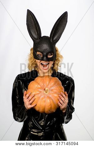 Happy Woman In Bunny Mask With Jack O Lantern. Woman In Bunny Mask With Pumpkin. Halloween Costume. 