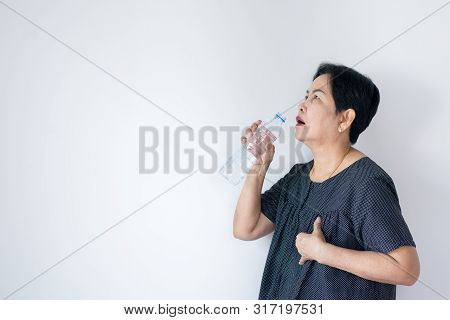 Senior Asian Woman Having Or Symptomatic Reflux Acids,gastroesophageal Reflux Disease,drinking Water