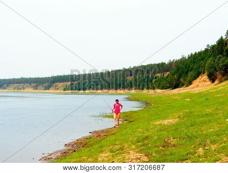 Yakut Asian Girl The Lady Angler Goes Fishing Spinning Reel In Shorts Along The Wild North Of The Vi