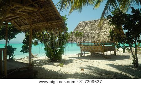 Bungalow On A Tropical Beach With Palm Trees And Blue Sea Of Daco, Philippines. Summer And Travel Va