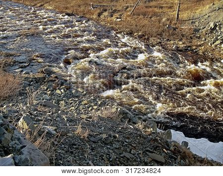 Melting Snow In The Spring. The Spring Heat Will Melt The Snow. Brooks And Streams Of Melt Water