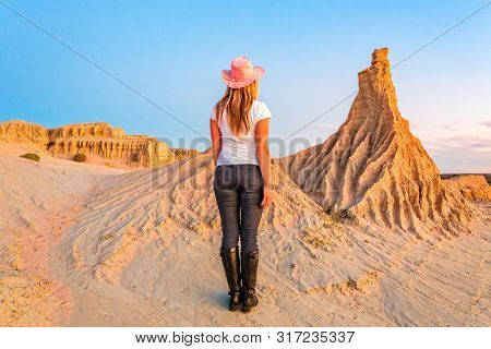 A Female Tourist Walks Among The Landforms Of The Lunette At Mungo National Park In The Outback Dese