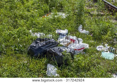 A Package With Garbage On The Railway Thrown Out From The Window Of The Train By Passengers, Polluti