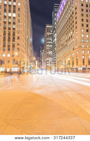 Wacker Dr Street With Tall Buildings And Street Light Trails In Chicago At Night