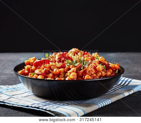 Garbanzos Fritos, Hot Chickpea Stew With Sliced Chorizo, Ham, Tomatoes And Spices In A Black Bowl On