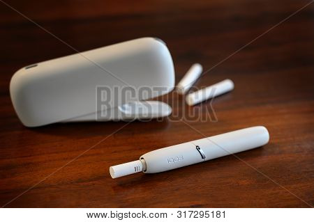 Rieps, Germany, August 15, 2019: Iqos Heating Tobacco System On A Brown Table, New E-cigarette With 