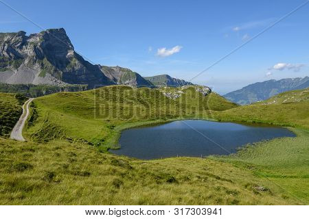 Mountain Lake At Melchsee-frutt In The Swiss Alps