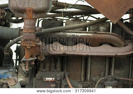 Engine On Old Rusty Tractor. Non-painted Metal