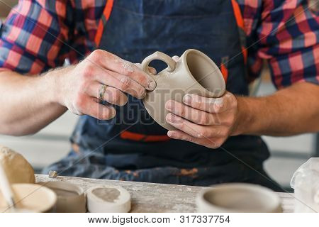 Male Potter Hands Making Ceramic Cap In The Pottery.