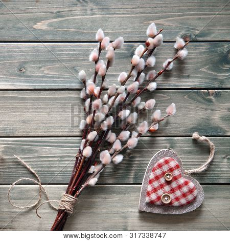 Springtime Background With Bunch Of Pussy-willow Twigs Tightened By Cord And Wooden Heart On Rustic 