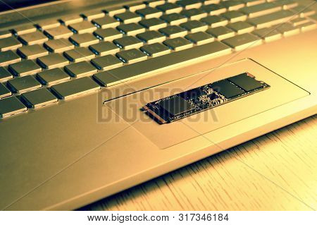 Chip Ssd-drive In The Center Of The Laptop Trackpad. Details Of The Chip In Sharpness. In The Light 