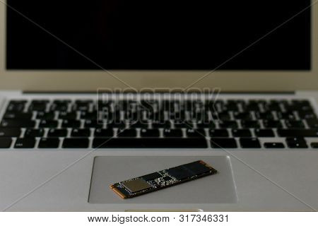 Ssd Drive Diagonally On The Trackpad. The Laptop Takes Up The Entire Frame Horizontally. Half Screen