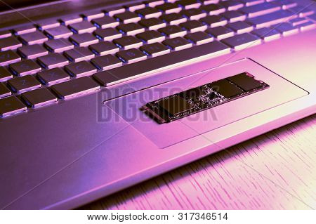 Fragment Of The Bottom Of The Netbook Diagonally. On The Trackpad Is Parallel To The Ssd Chip Of The
