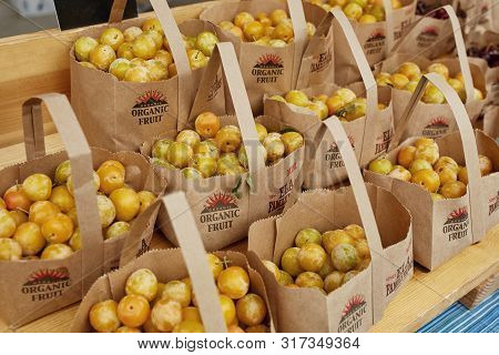 Boulder, Colorado - August 10th, 2019: Brown Bags Of Organic Shiro Plums For Sale At A Farmers Marke