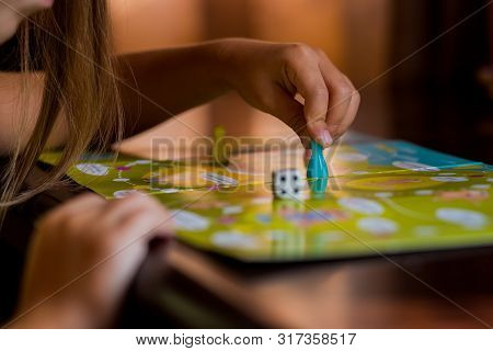 Multi-colored Game Chips With Dice On The Playing Board. Board Game.children Sit In Kindergarten At 