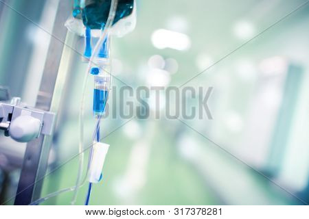 Blue Intravenous Drip In The Hospital Foyer As A Concept Of Assisted Death.