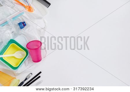 Plastic items on white background, flat lay
