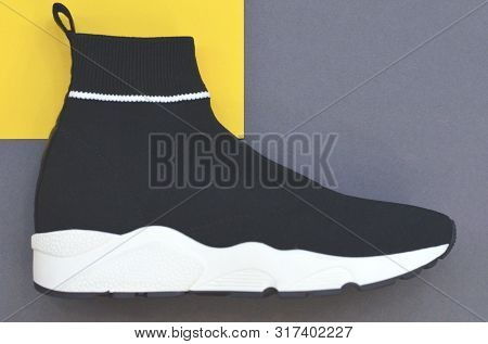Beautiful Fashionable Socks Sneakers On A Yellow-gray Background. Fashionable Womens And Mens Shoes.