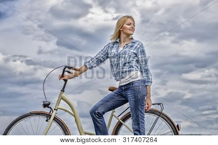Active Leisure And Healthy Activity. Girl Ride Cruiser Model Bicycle. Woman Rides Bicycle Sky Backgr