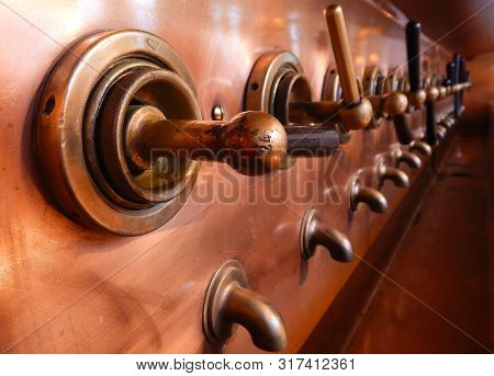 Beer Taps In A Line At A Brewery