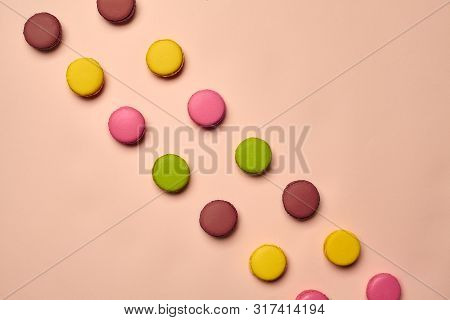 Colored Macaron Or Macaroon, Sweet Meringue-based Confection On Pink Background. Close-up, Copy Spac