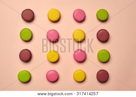 Colored Macaron Or Macaroon, Sweet Meringue-based Confection On Pink Background. Close-up, Copy Spac