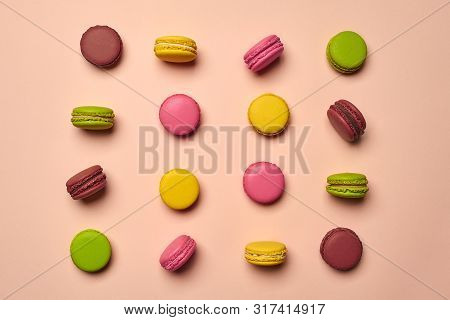 Colored Macaron Or Macaroon, Sweet Meringue-based Confection On Pink Background. Close-up, Copy Spac