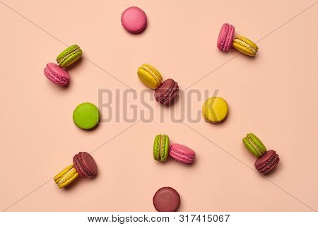 Colored Macaron Or Macaroon, Sweet Meringue-based Confection On Pink Background. Close-up, Copy Spac