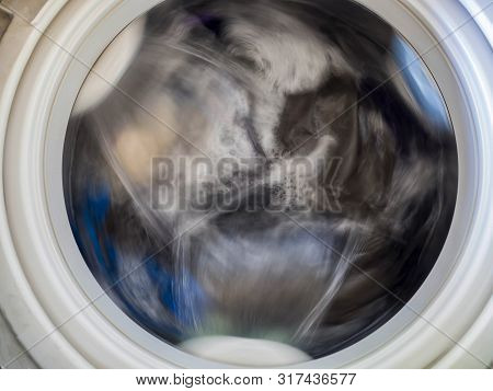 Top Loading Washing Machine Washes Laundry. Internal View Of A Washing Machine Drum During Wash. Top