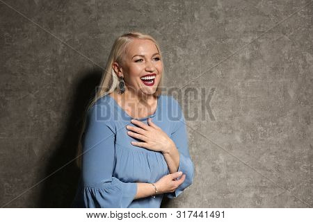 Portrait Of Beautiful Mature Woman On Grey Background, Space For Text