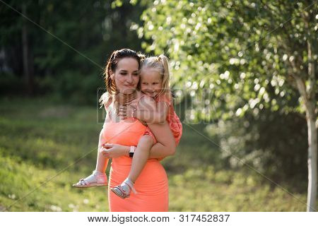 Happy Mother Playing With Her Little Baby Girl Daughter And Having Fun - Young Caucasian White Mom W