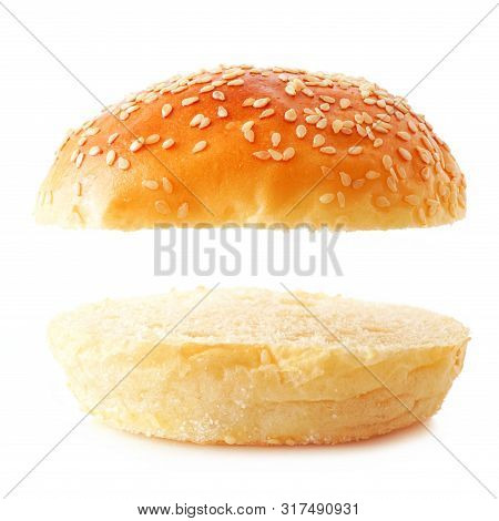 Open Sesame Seed Hamburger Bun On A White Background. Top And Bottom Isolated With Copy Space.