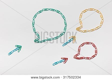 Communication Bubble All Made From Paperclips Of Different Colors On White Background , Shot From Ab