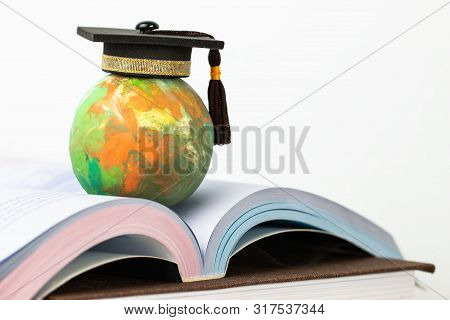 Study Abroad Education In Global Ideas: Graduated Cap On Top Global Model On Open Textbook In Librar