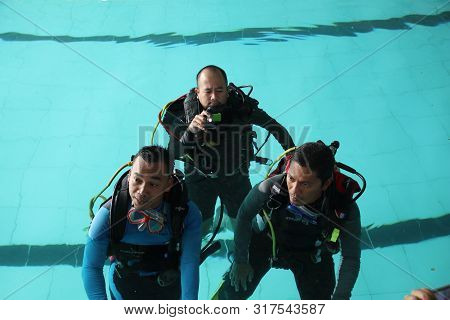 A Group Of People Doing Diving Training In A Swimming Pool In Batang / Central Java, Indonesia, Augu