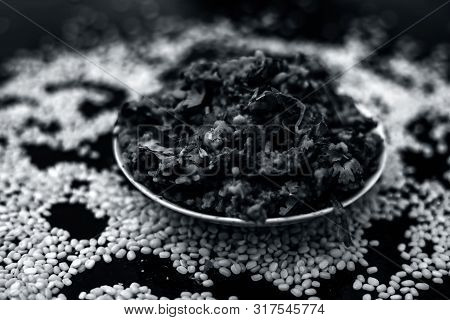 Famous Indian Punjabi Dish I.e. Roasted Dal With Spinach In A Glass Plate On The Wooden Surface Alon