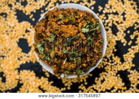Famous Indian Punjabi Dish I.e. Roasted Dal With Spinach In A Glass Plate On The Wooden Surface Alon