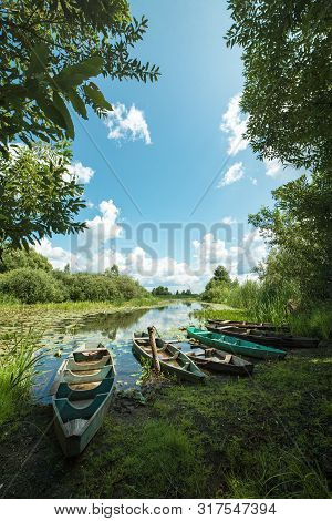Beautiful Scenery Of Wooden Fishing Boat On The River. Fishery Boat On The River. Old Wooden Boat.