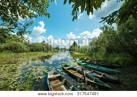 Beautiful Scenery Of Wooden Fishing Boat On The River. Fishery Boat On The River. Old Wooden Boat.
